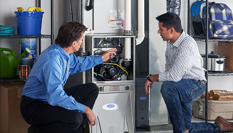 HVAC technician evaluating a furnace for repair or replacement in Bountiful