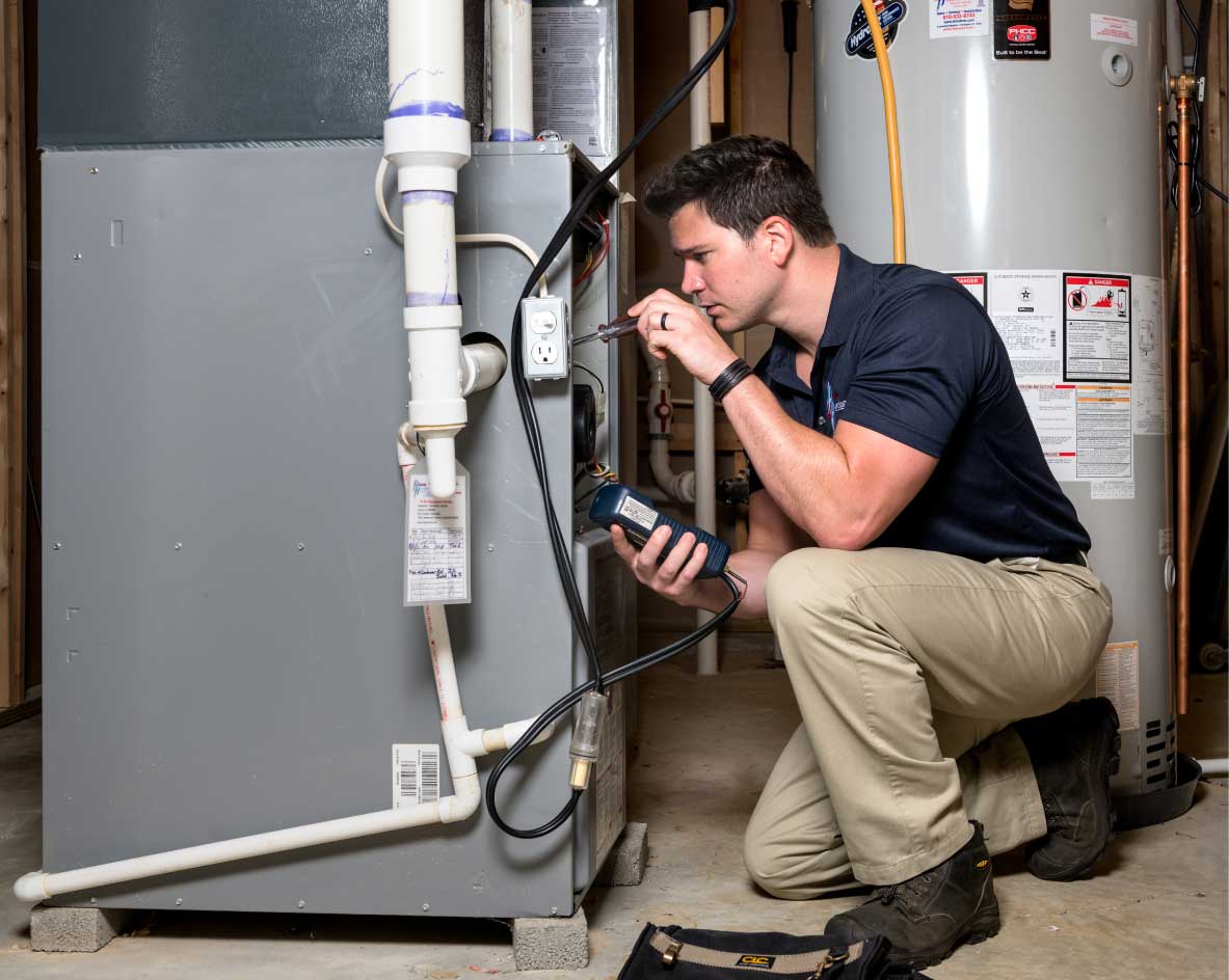 HVAC technician performing a furnace tune-up in Bountiful