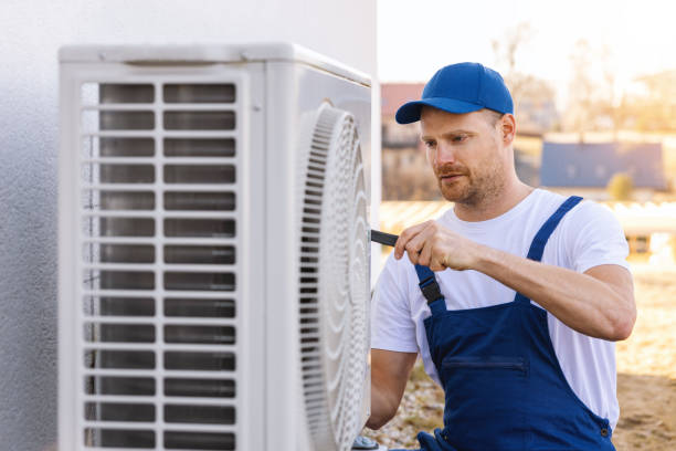 HVAC technician servicing an outdoor air conditioning unit in Bountiful