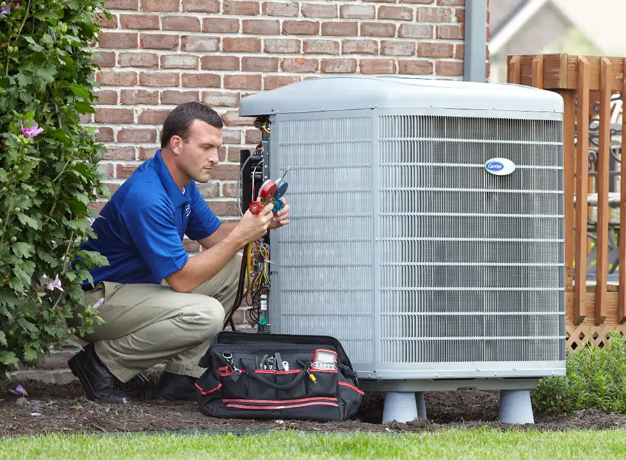 HVAC technician inspecting an outdoor air conditioning unit in Bountiful