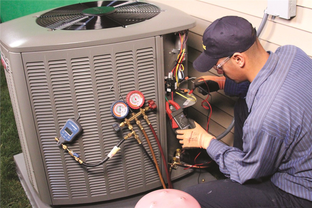 HVAC technician testing an outdoor air conditioning unit in Bountiful